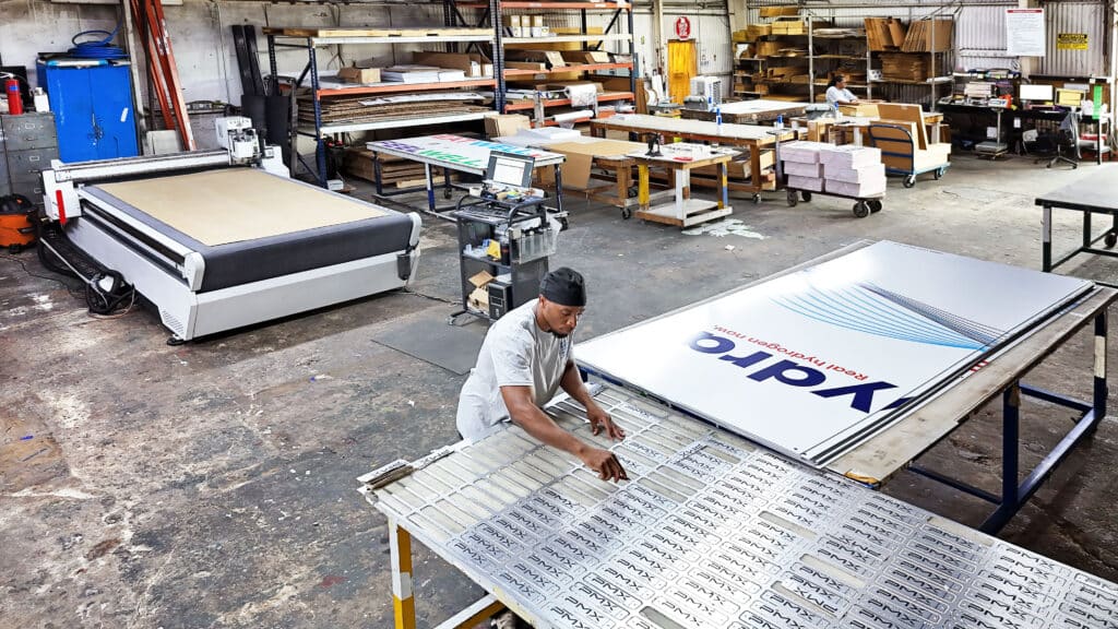 Houston Sign Company production floor, with printed aluminum sign panels being finished before installation